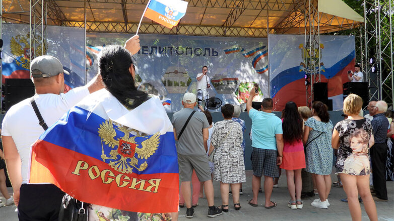 Запорожская область, Мелитополь. Местные жители с флагами России