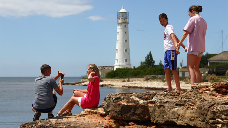 Люди во время отдыха у маяка на мысе Тарханкут, Крым