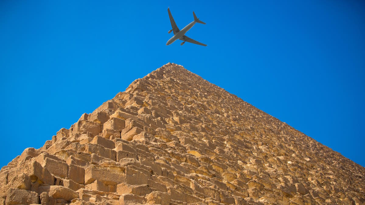 Самолёт пролетает над египетской пирамидой