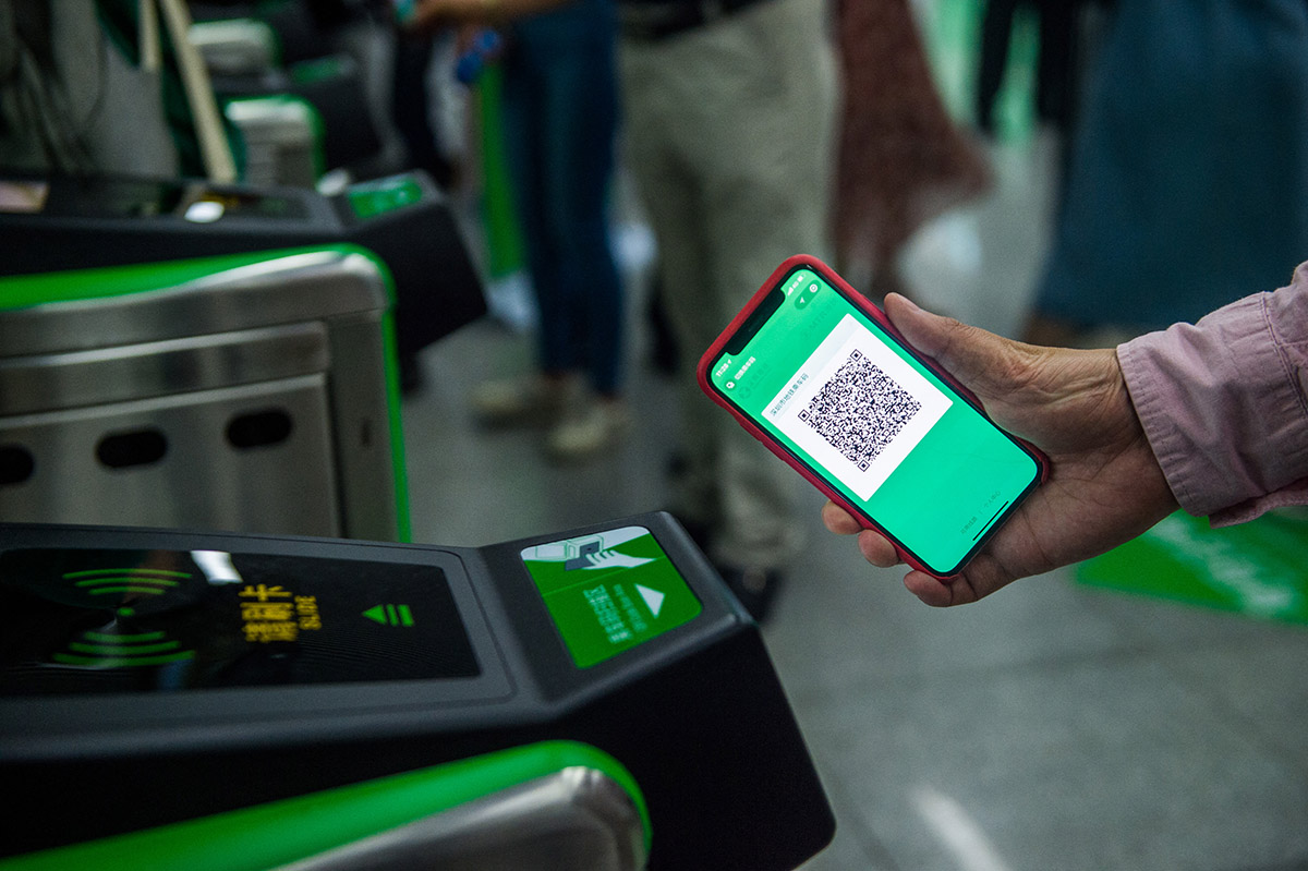 Пассажир сканирует QR-код со своего смартфона через мобильное приложение WeCha